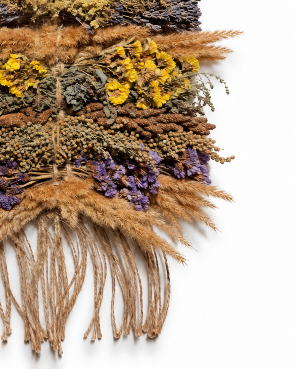 Detailed close-up of yellow dried blooms, purple statice, and hanging jute twine fringe.

