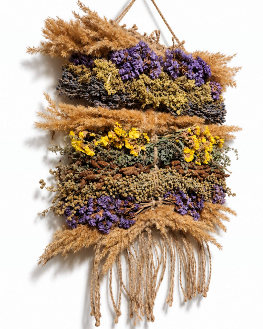 Side angle of a 20x30cm dried lavender and wild grass wall tapestry with jute fringe.
