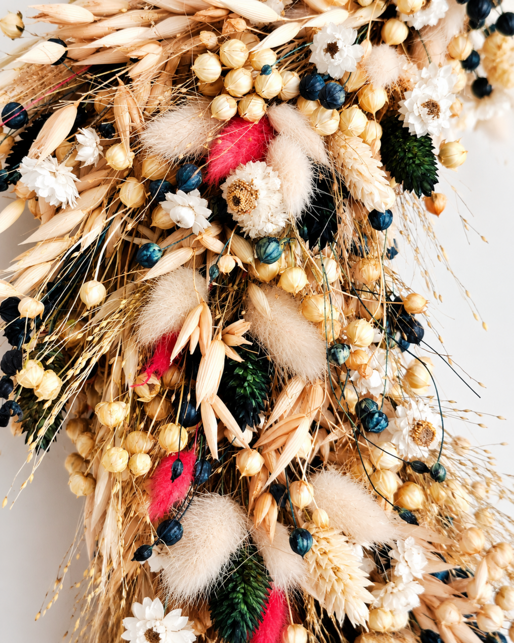 Macro texture view of natural dried botanicals, lagurus, and white blooms.
